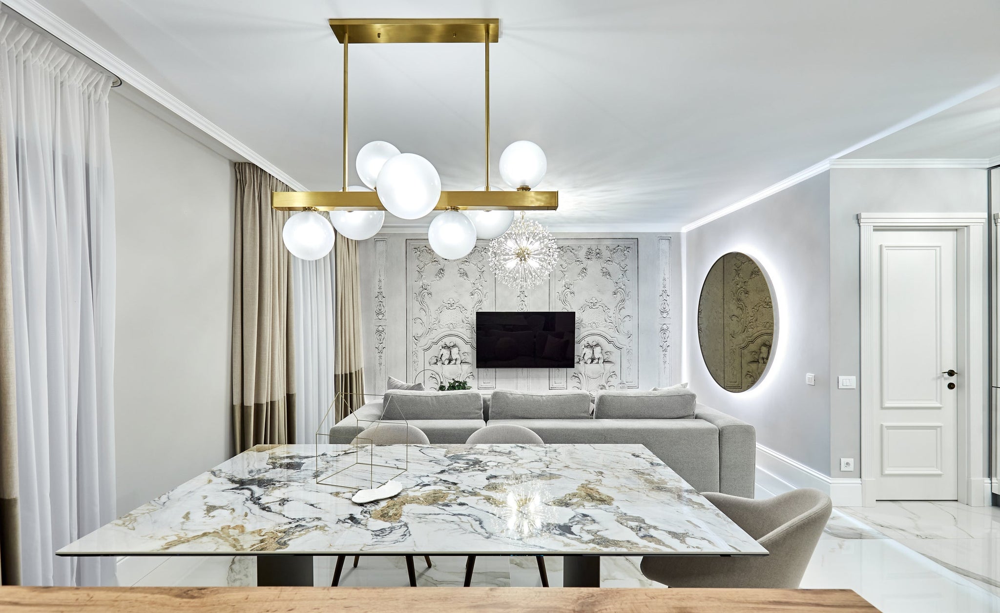 Hinsdale Linear in aged brass styled in a kitchen island for warm, layered light at Laurie Yapp Home.