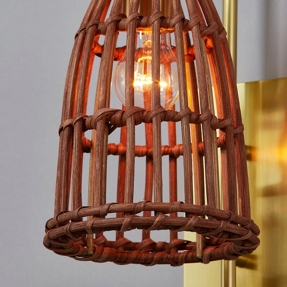 Jordan Wall Sconce in aged brass shown from a second angle to highlight the arm curve and shade silhouette.