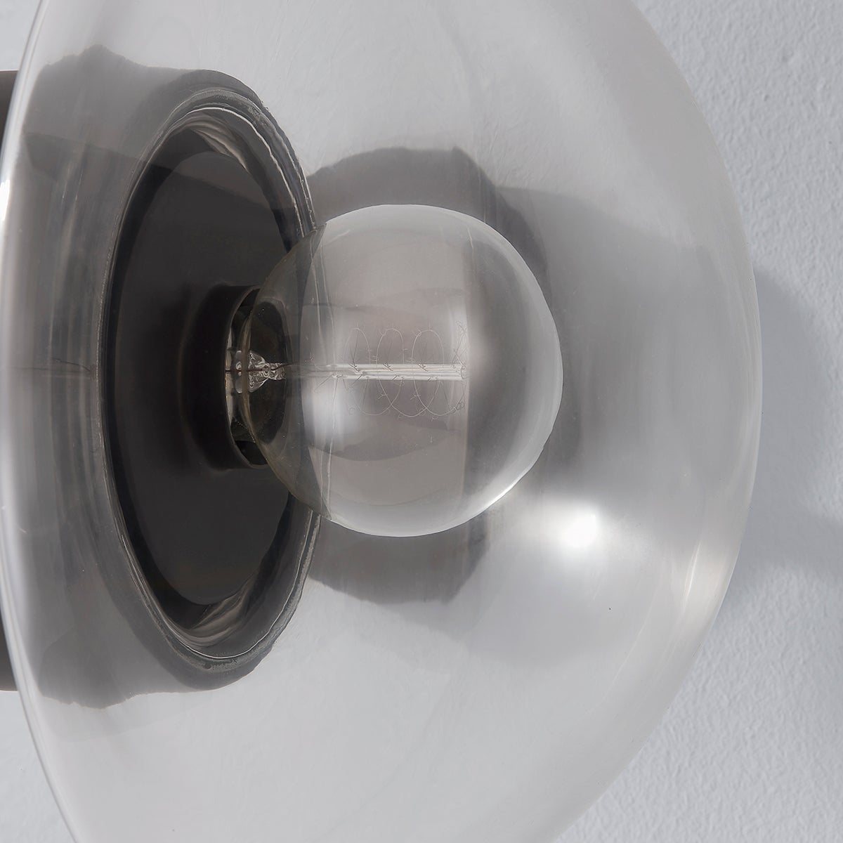 Close-up of the Kert Wall Sconce showing the arm curve and shade silhouette.
