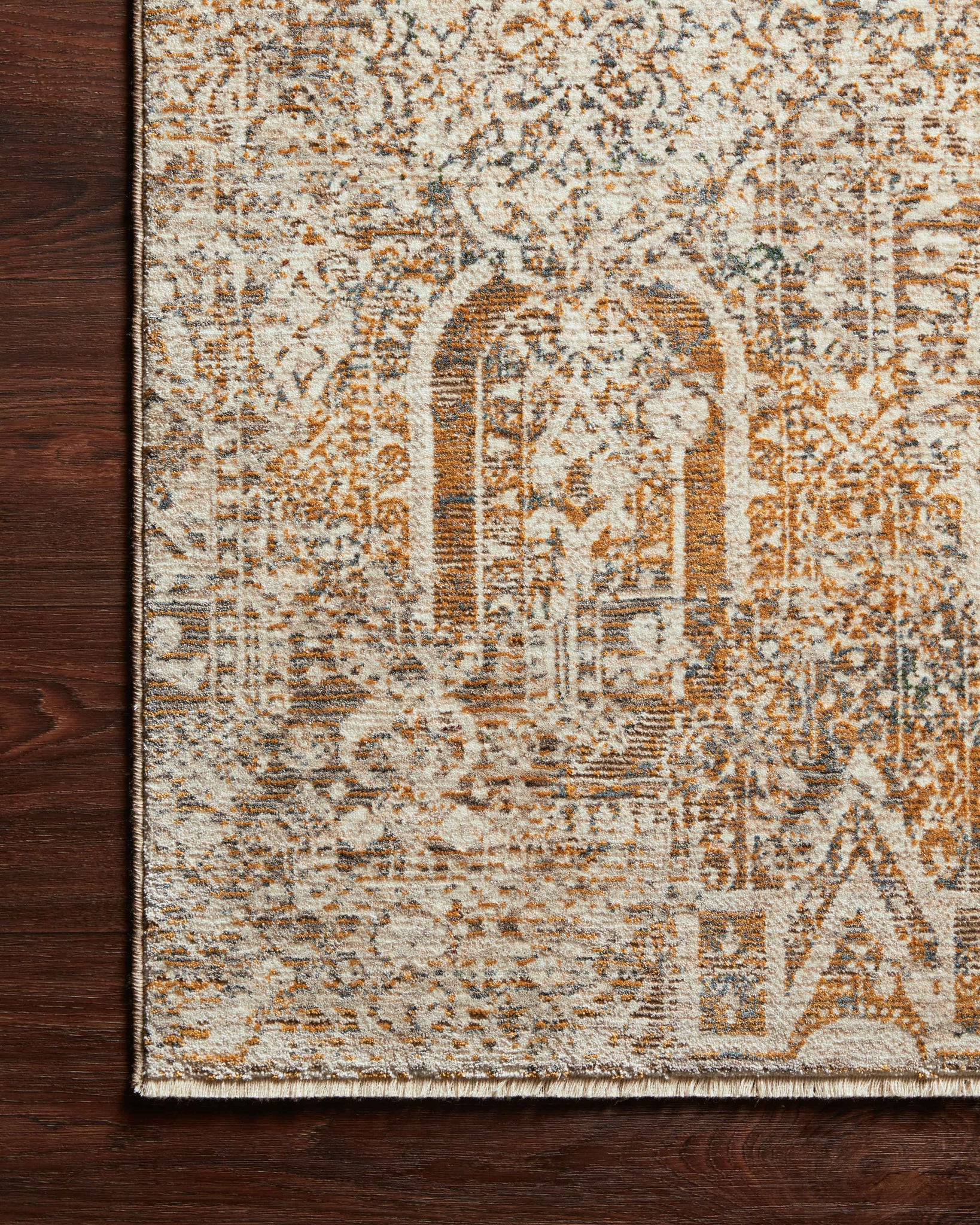 Side view of the Lourdes Ivory / Orange rug.