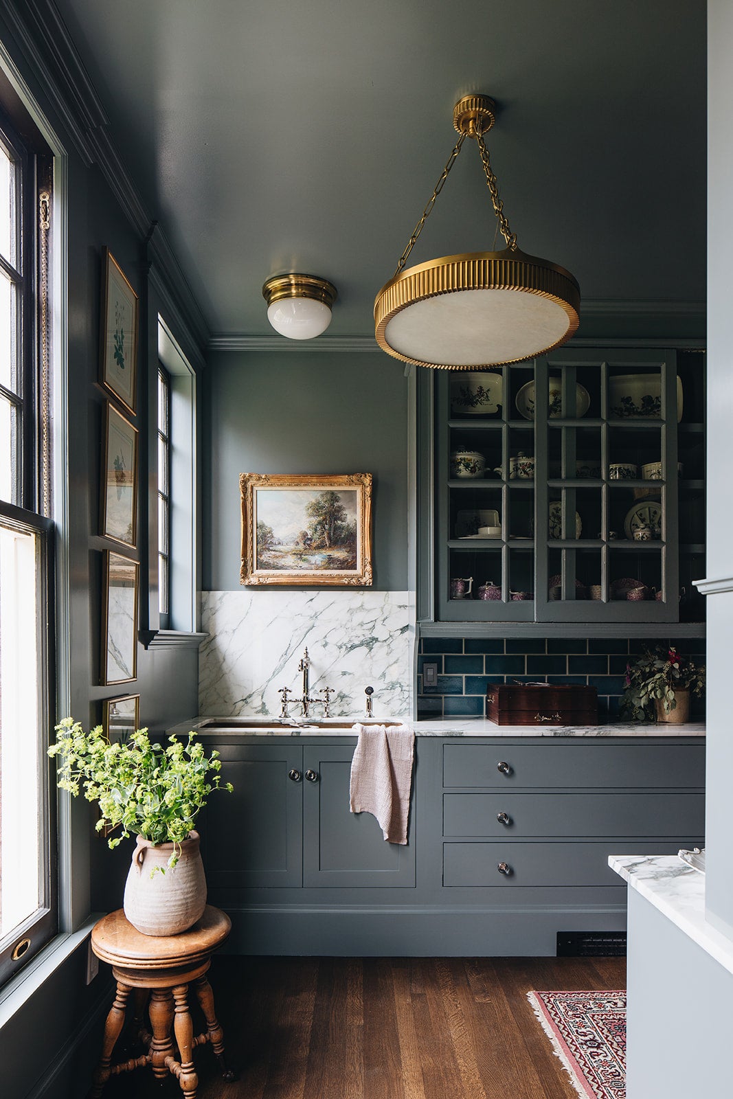 Lynden Chandelier 22" in aged brass styled in an elegant dining room for warm, layered light at Laurie Yapp Home.
