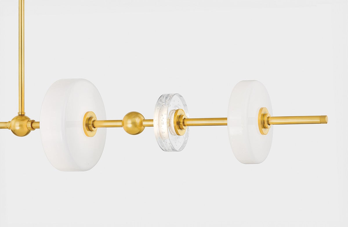 Maynard Linear in aged brass shown from the front to reveal the extended frame and shade array.