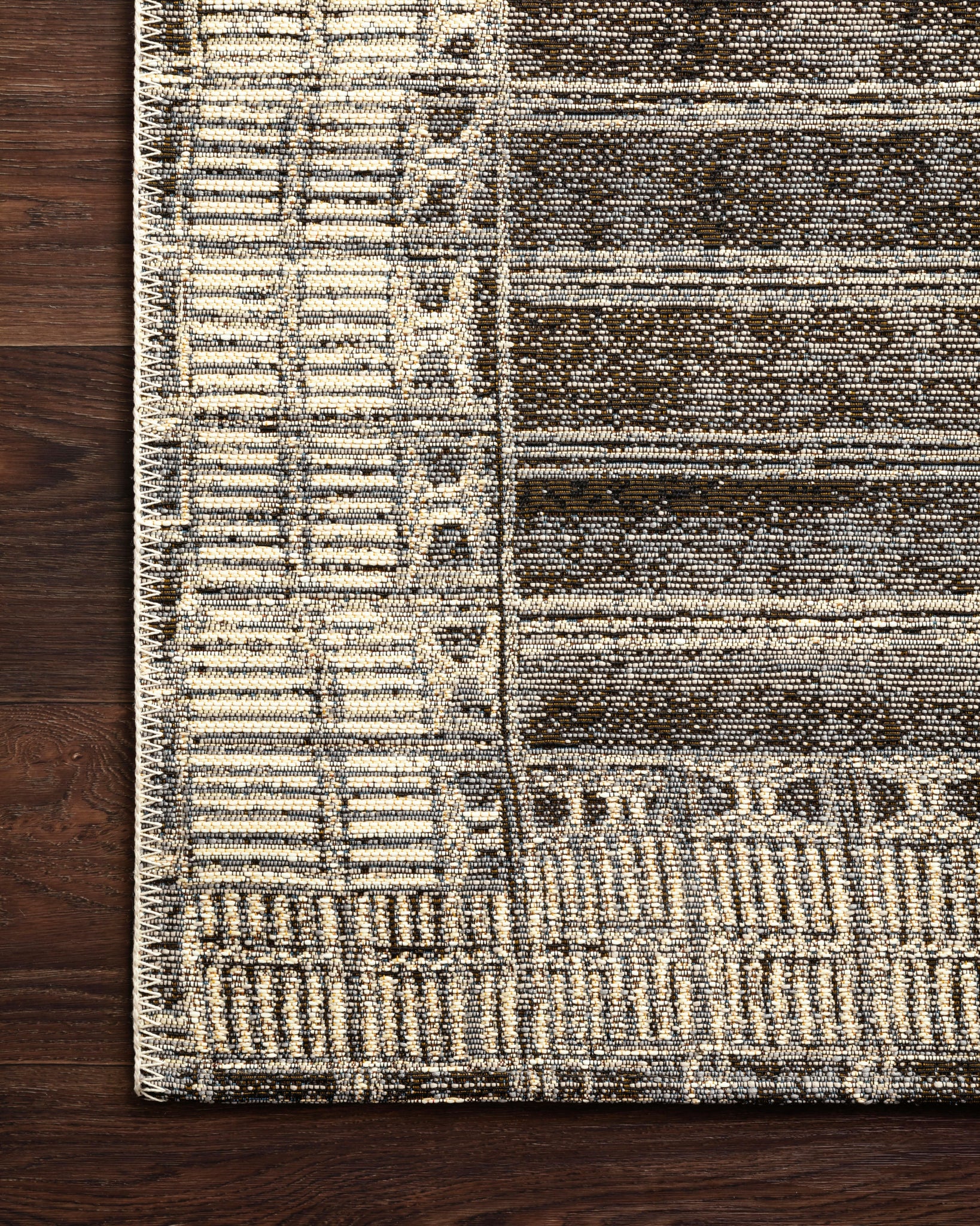 Close-up detail of the Mika Charcoal / Ivory showing its pile and weave.