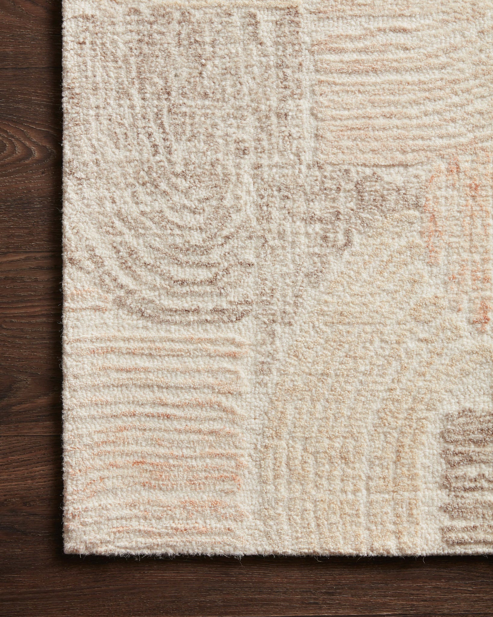 Side view of the Milo Peach / Pebble rug.