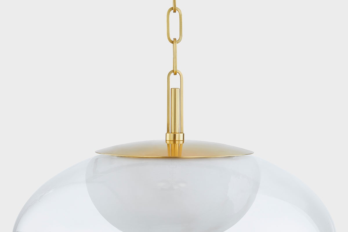 Close-up of the Moore Pendant 17" in aged brass showing the shade shape and metal detail.