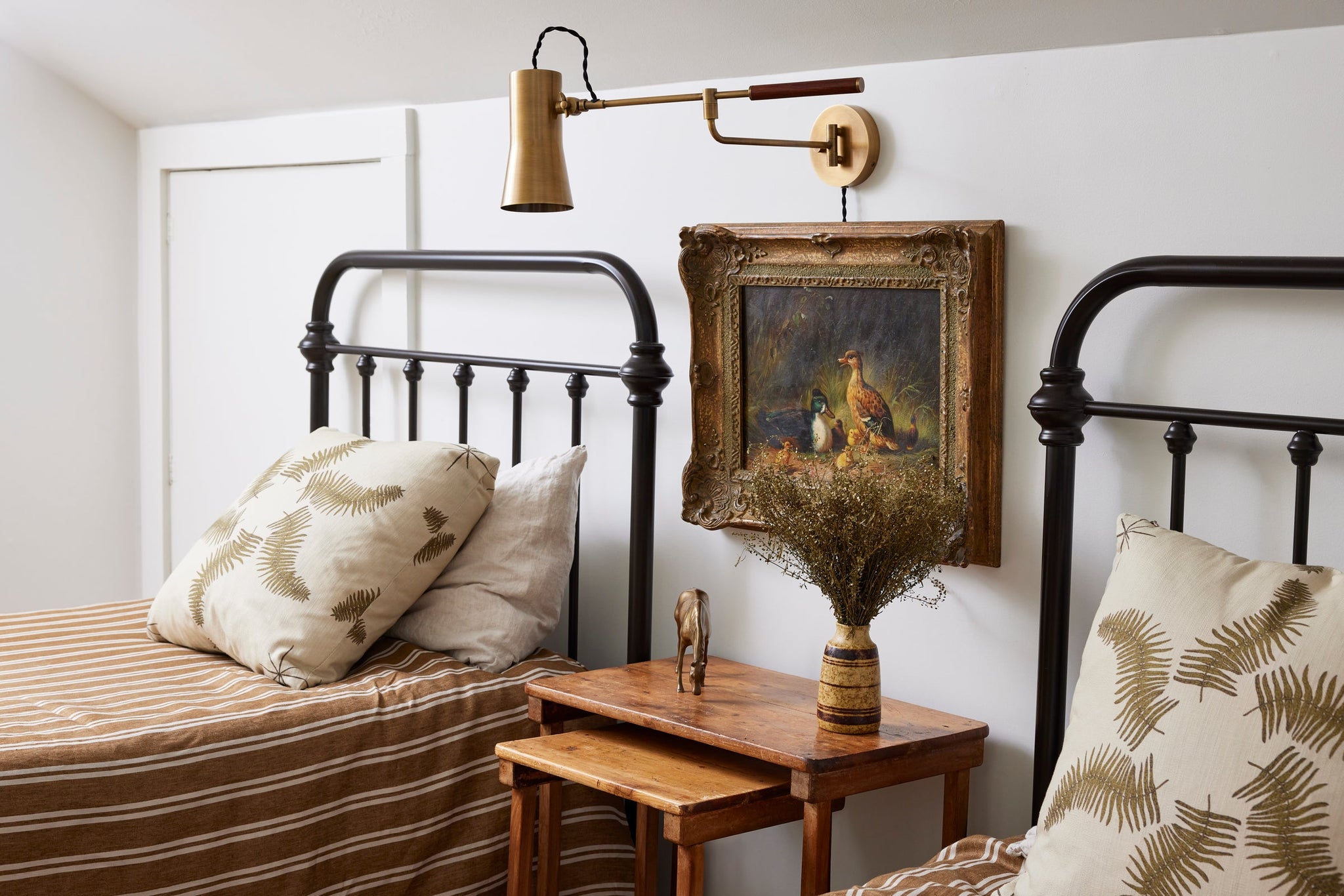 Novel Plug-In Sconce styled in a reading nook for warm, layered light at Laurie Yapp Home.
