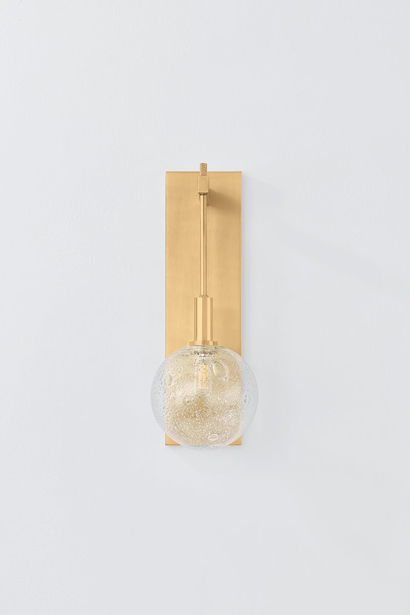 Onteora Wall Sconce in aged brass shown from the front to reveal the arm curve and shade silhouette.