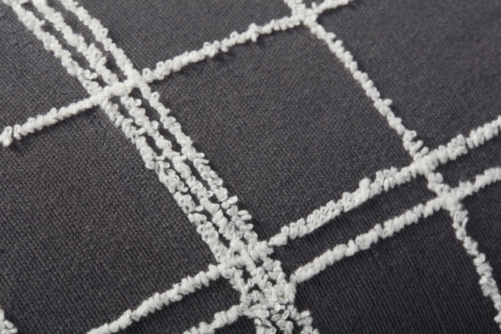 Bernadette Graphite / Ivory Pillow shown from a different angle to reveal its pattern.