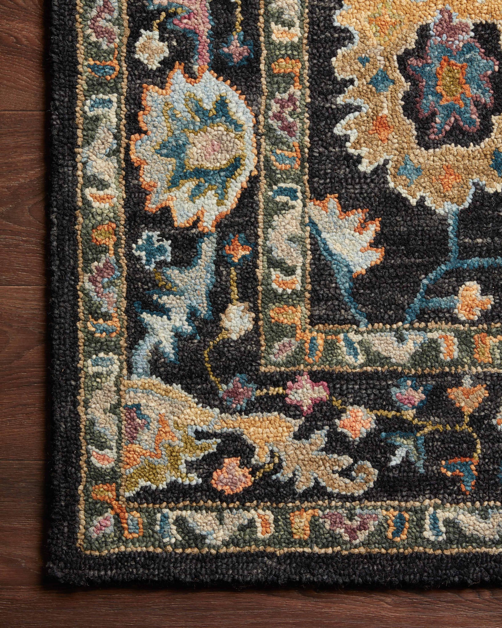 Side view of the Padma Black / Multi rug.
