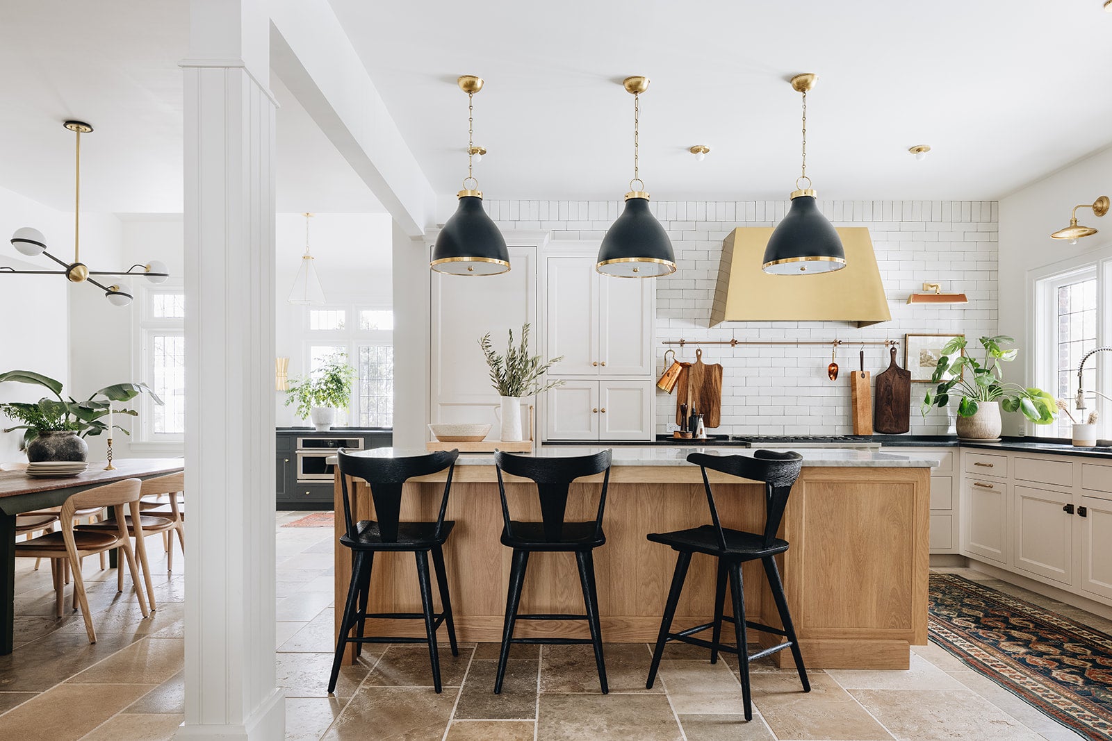 Eldridge Pendant 15.5" x 22" in aged brass styled in a welcoming entryway for warm, layered light at Laurie Yapp Home.