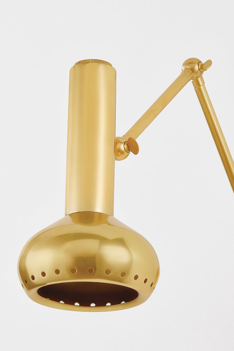 Close-up of the Roald Wall Sconce in aged brass showing the arm curve and shade silhouette.