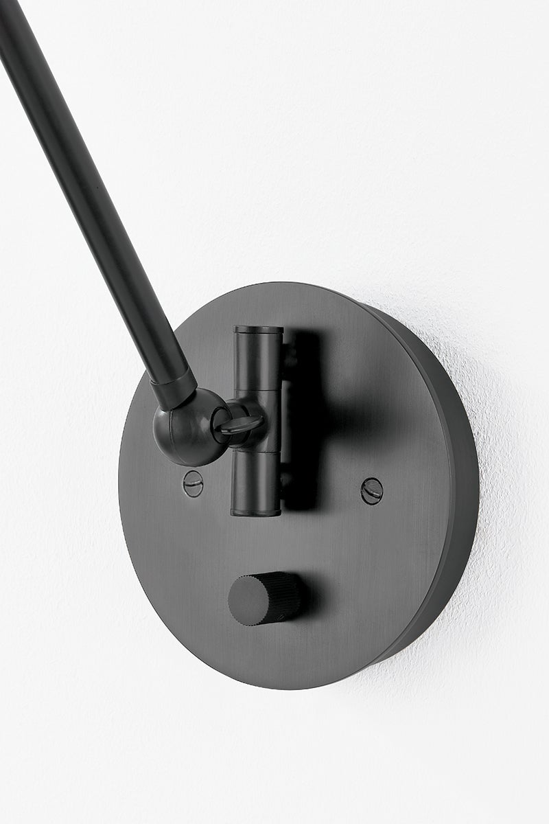 Close-up of the Roald Wall Sconce in dark bronze showing the arm curve and shade silhouette.
