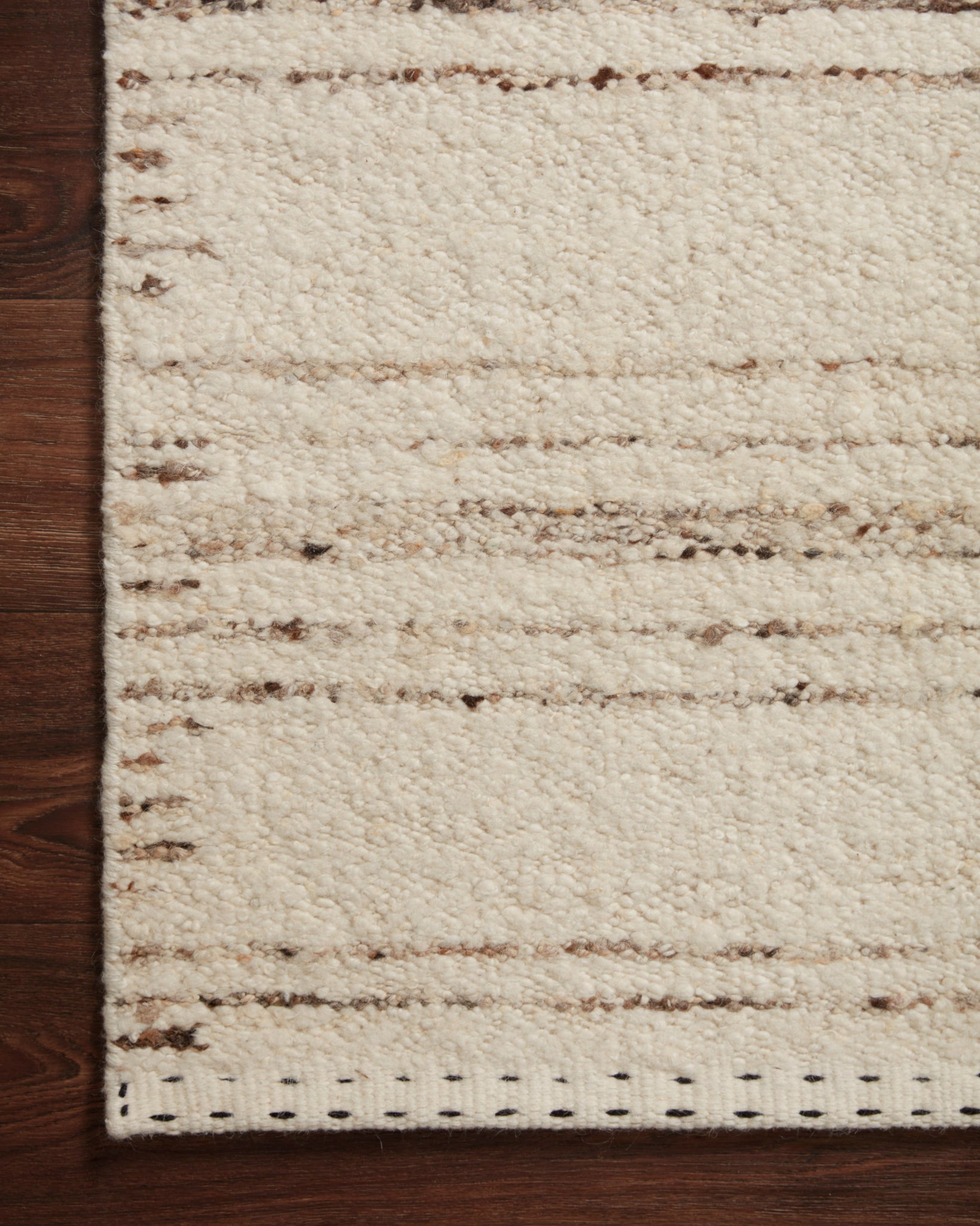 Side view of the Roman Ivory / Pebble rug.