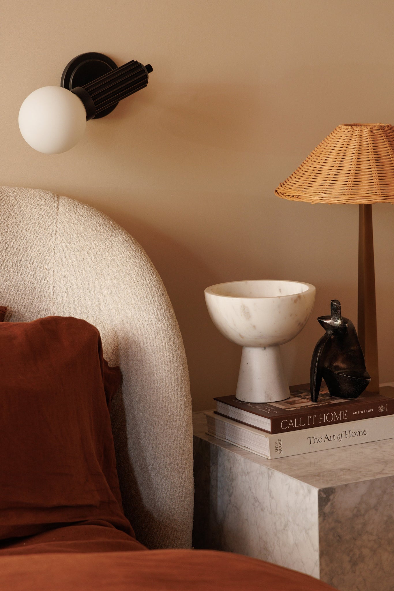 Reade Wall Sconce in Aged Brass styled in a modern bathroom for warm, layered light at Laurie Yapp Home.