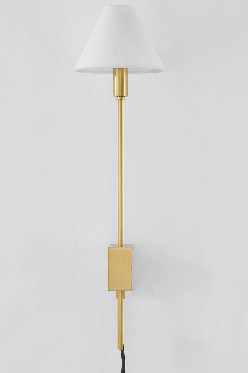 Teaneck Plug-In Sconce in aged brass shown from a second angle to highlight the arm profile and shade silhouette.