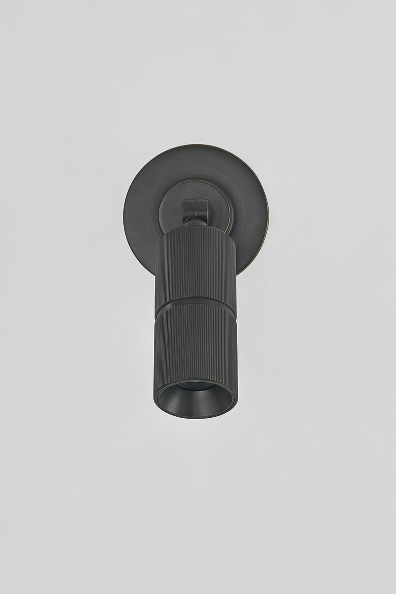 Close-up of the Truett Wall Sconce in dark bronze showing the arm curve and shade silhouette.