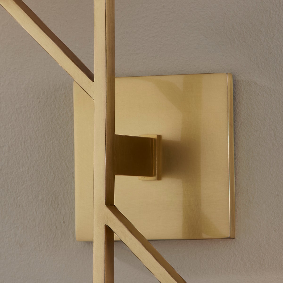Close-up of the Tring Wall Sconce in aged brass showing the arm curve and shade silhouette.