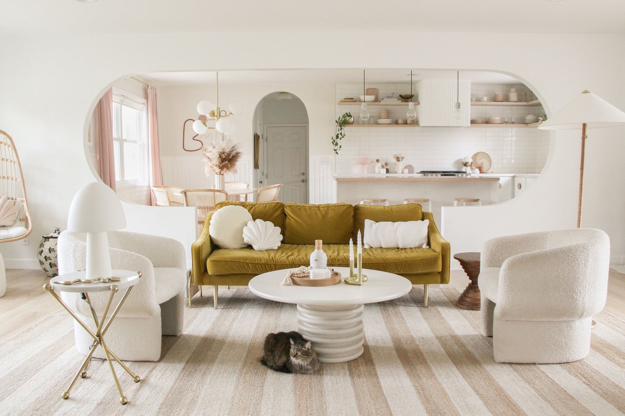 Flare Floor Lamp in aged brass styled in a bedroom for warm, layered light at Laurie Yapp Home.