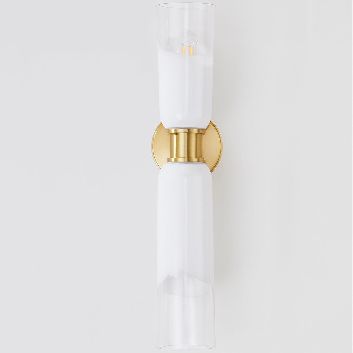 Close-up of the Wasson Wall Sconce in aged brass showing the arm curve and shade silhouette.