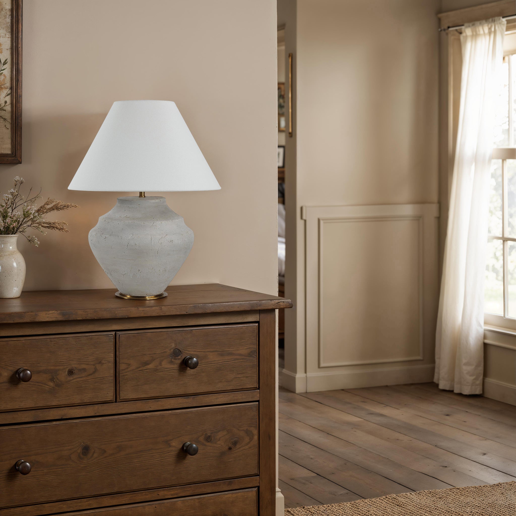Iulia Table Lamp placed on a wooden dresser in a softly lit room