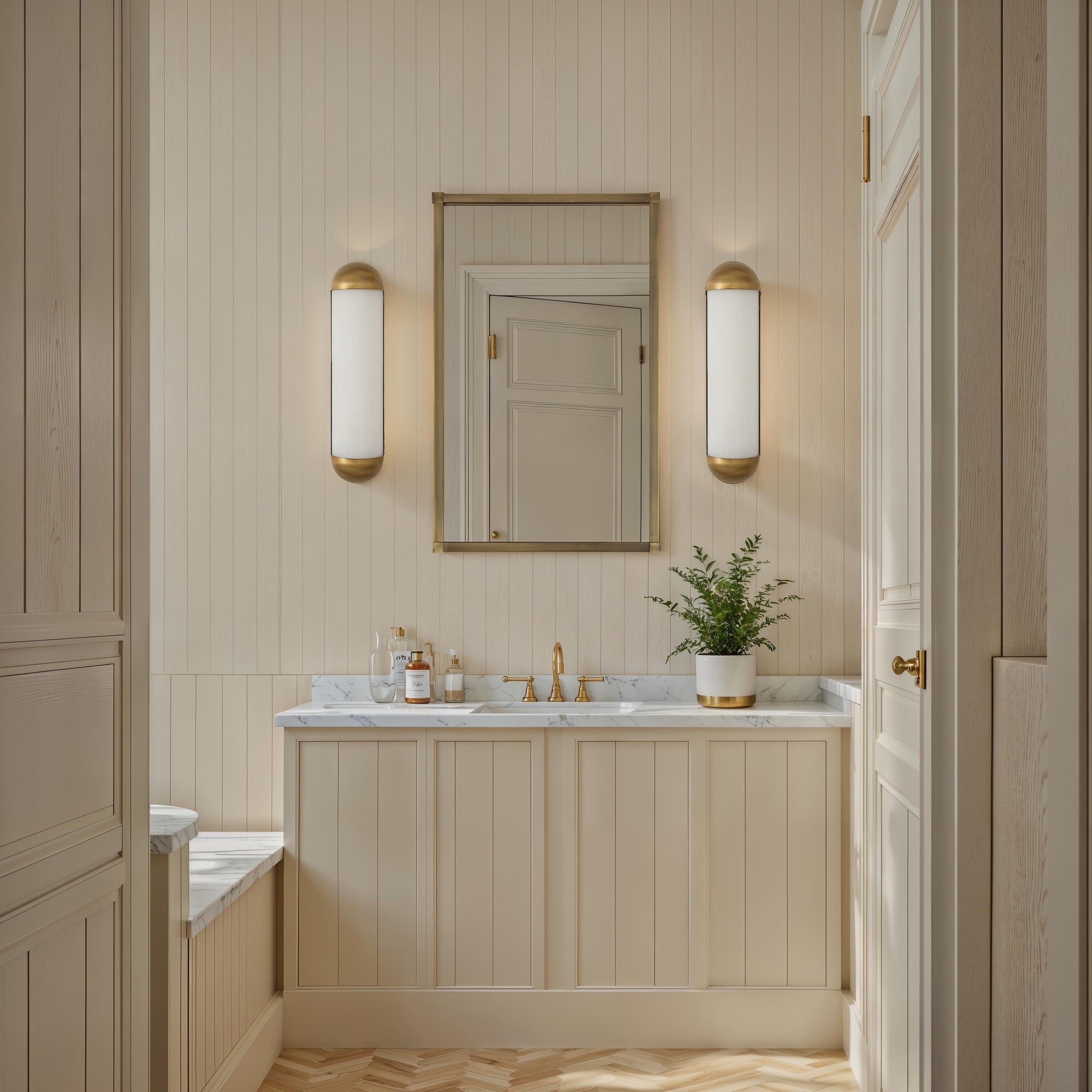 Amici wall sconce in a modern bathroom with beige paneling and marble countertop