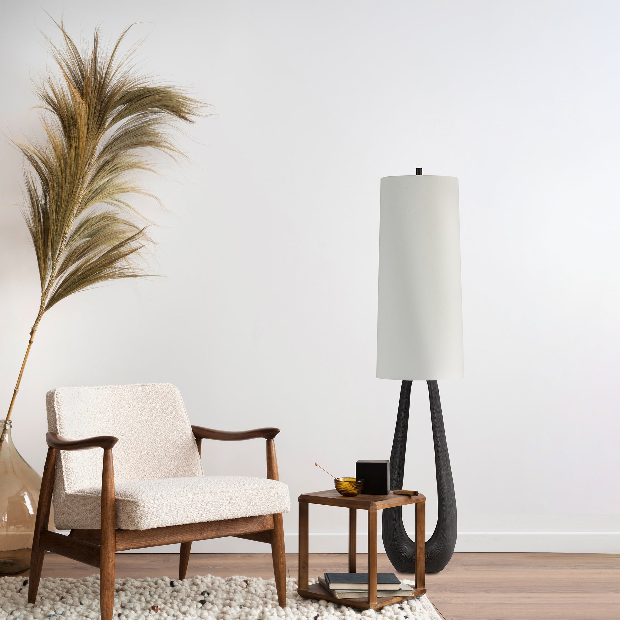 Cornelia floor lamp in a stylish living room setting with a cozy chair and decorative elements.