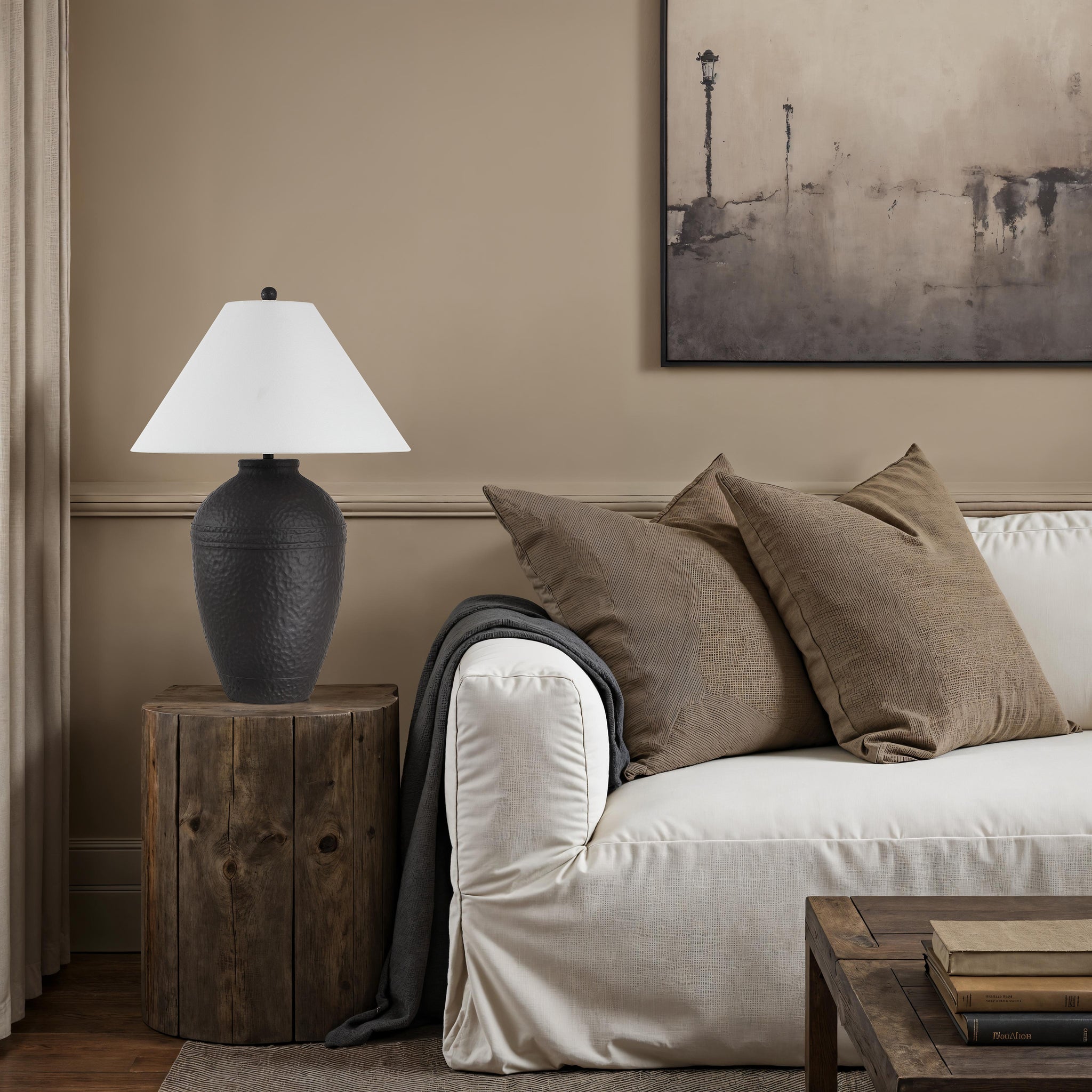 Cupper table lamp by Renwil on a wooden side table next to a sofa, featuring a white shade.