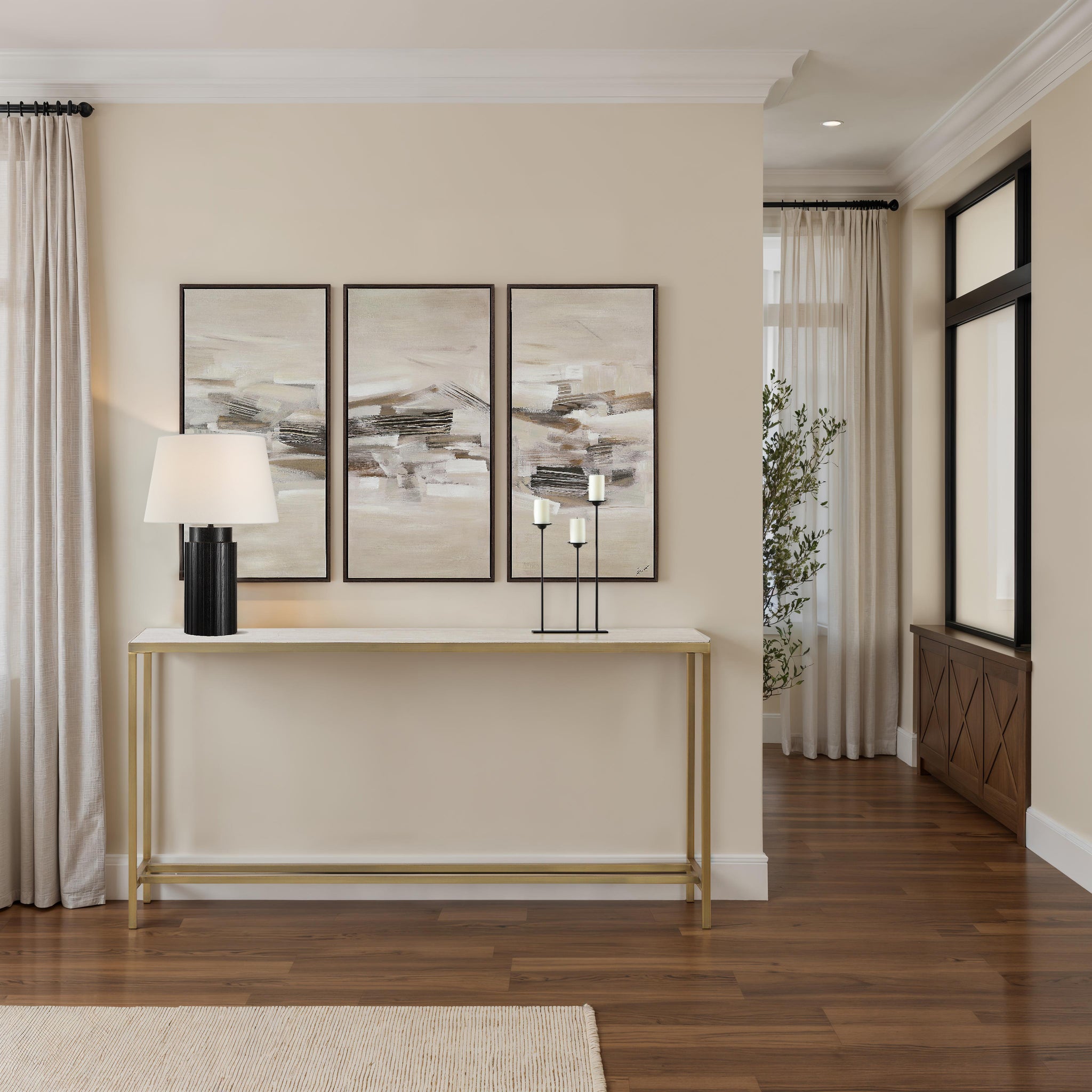 Bodin Console Table with a lamp and decorative candles, set against a light wall