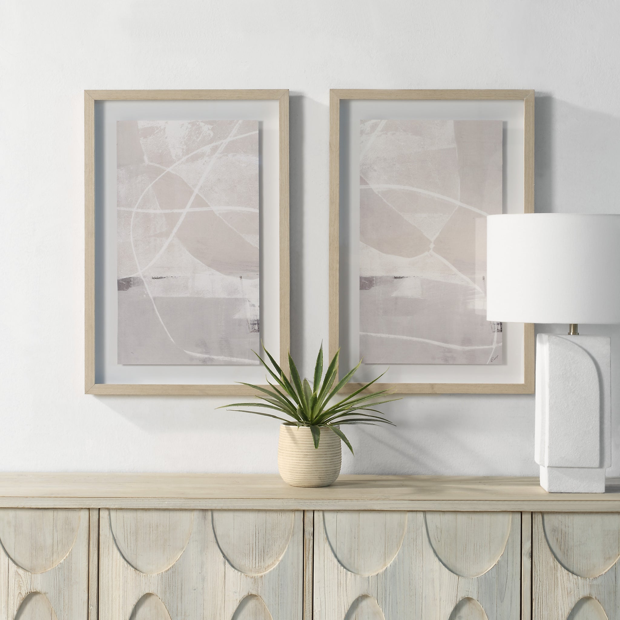 Rovereto Wall Decor displayed above a console table with a plant and lamp in a modern setting.