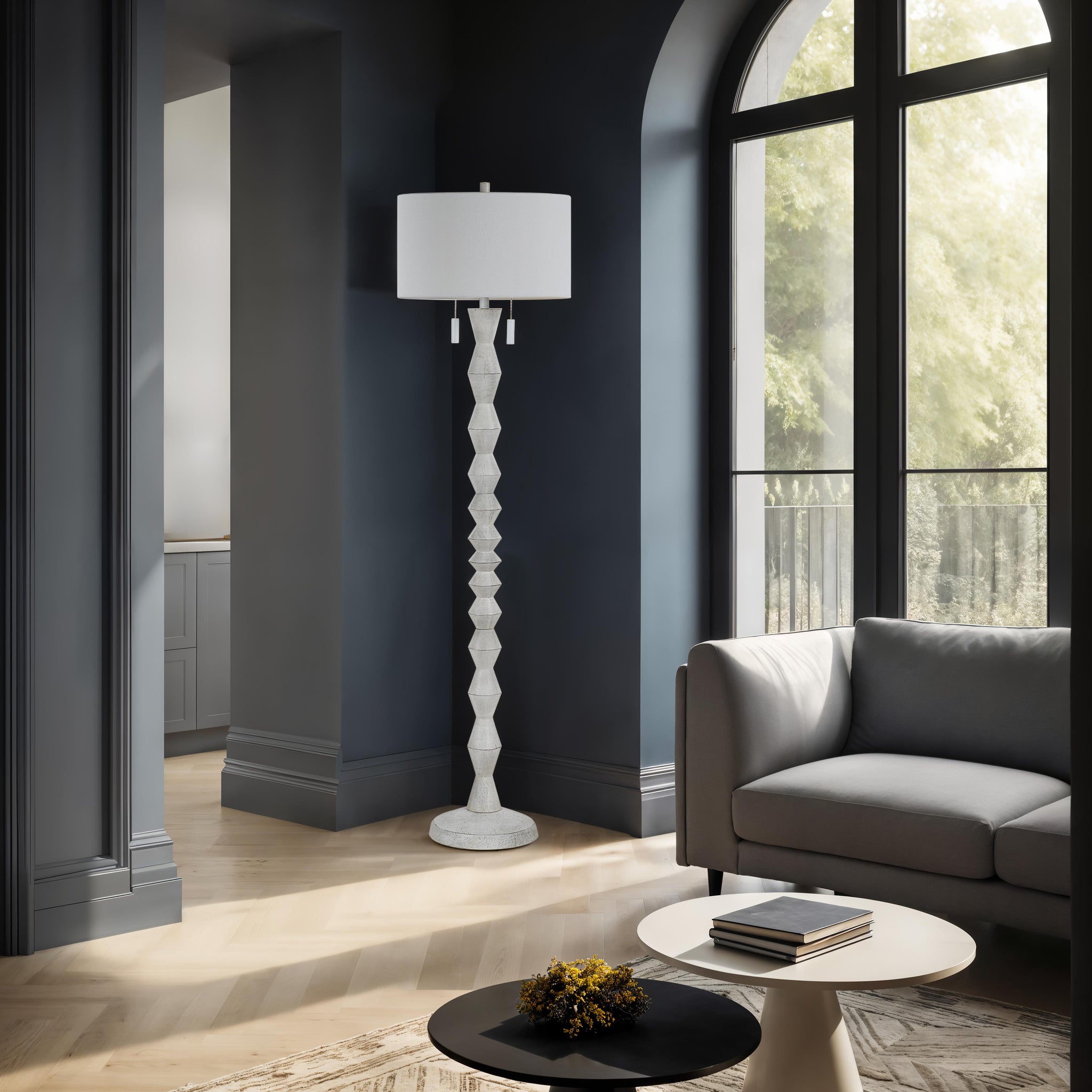 Sorriso floor lamp in a modern living room with dark walls and large windows.