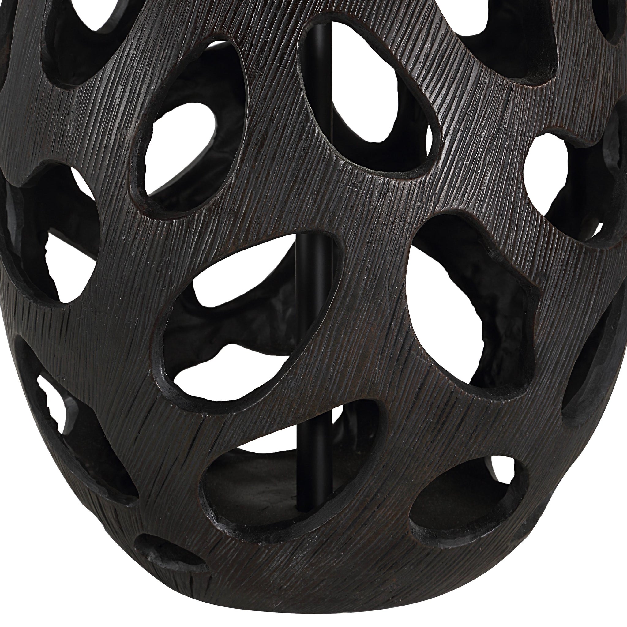 Close-up of Loxley Table Lamp's black base featuring cut-out patterns and textured surface.
