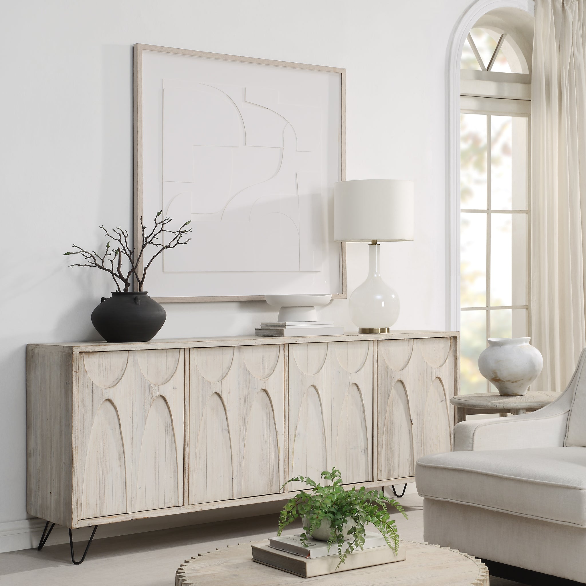 Stardust wall art displayed above a wooden sideboard in a bright living room setting.