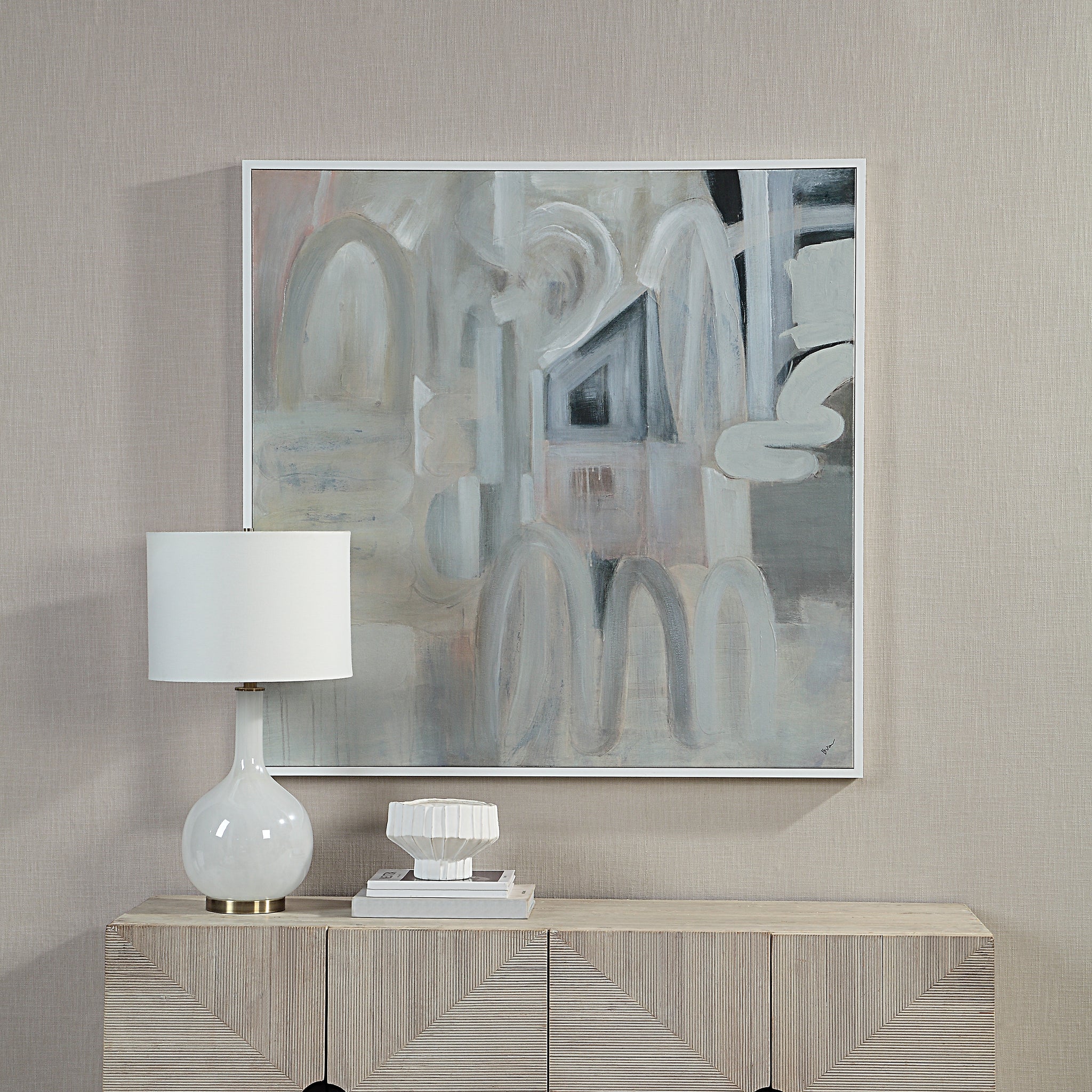 Palazzo canvas art hung on a wall above a wooden console with a lamp and decor.