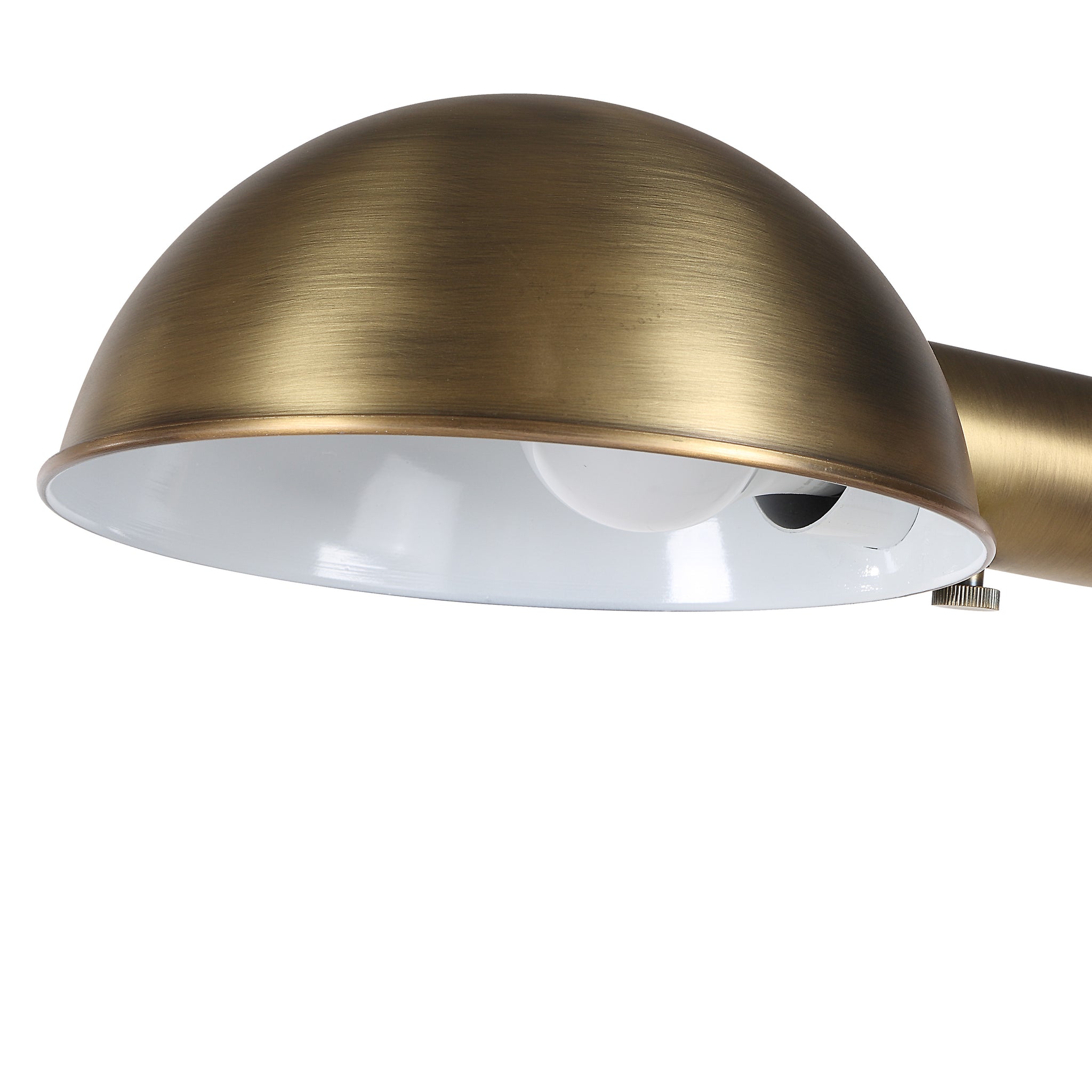 Close-up of Cos floor lamp's dome shade in brushed brass with a white interior.