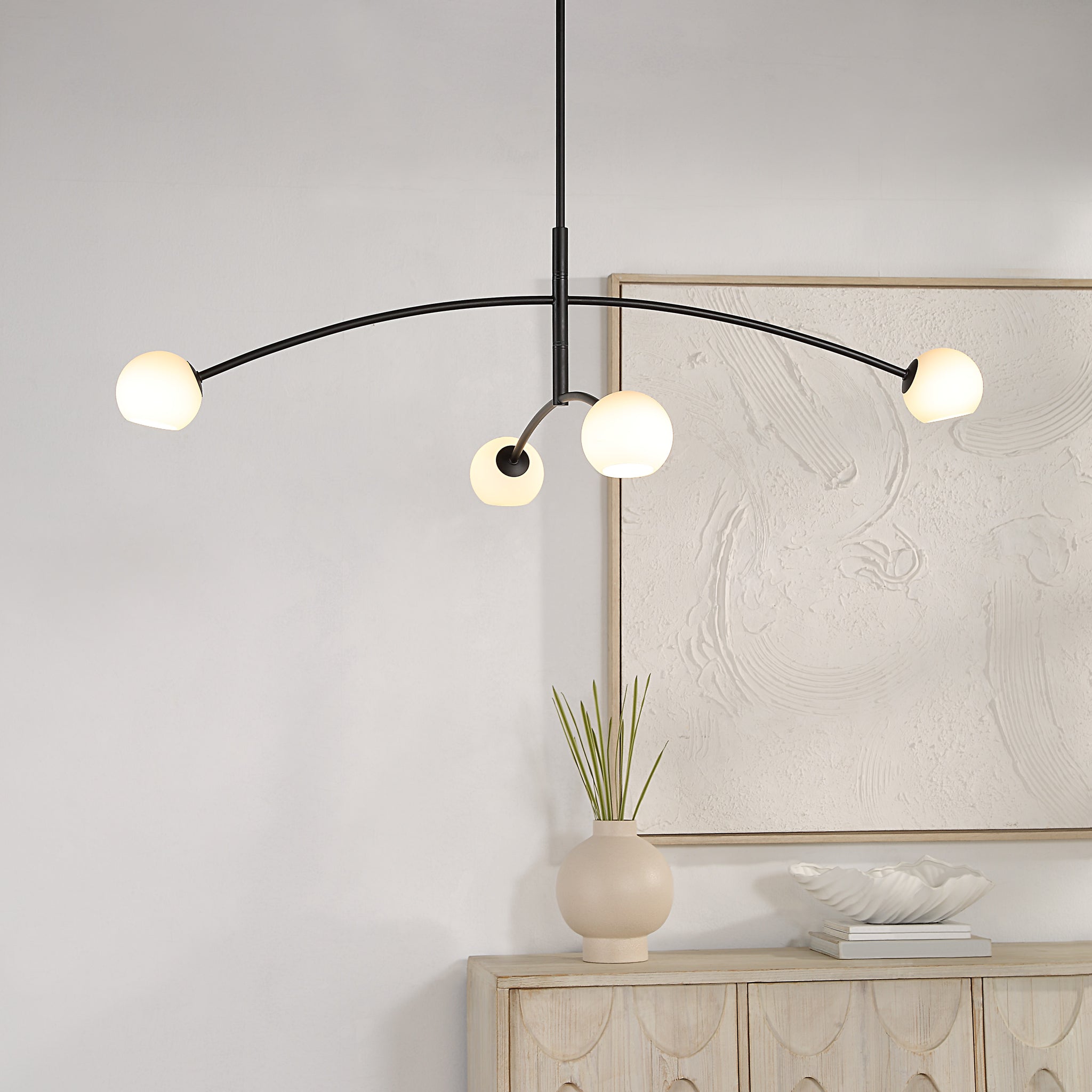 Nube Ceiling Fixture chandelier in a modern interior, featuring four white globes.