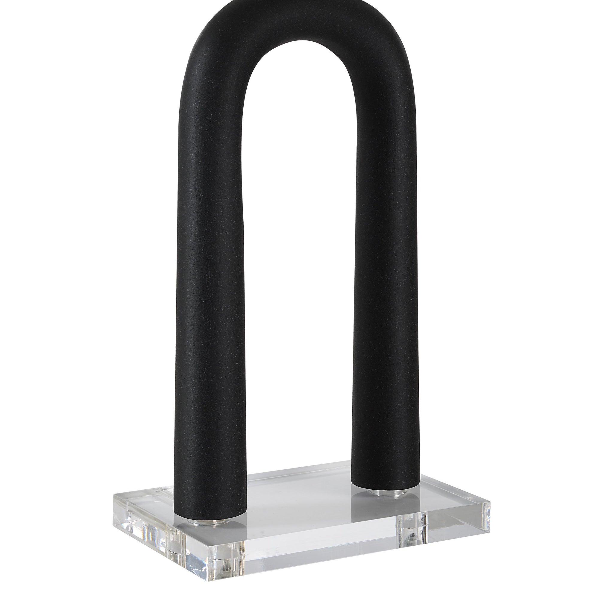 Close-up of Pisa Table Lamp showing black curved structure and clear acrylic base.