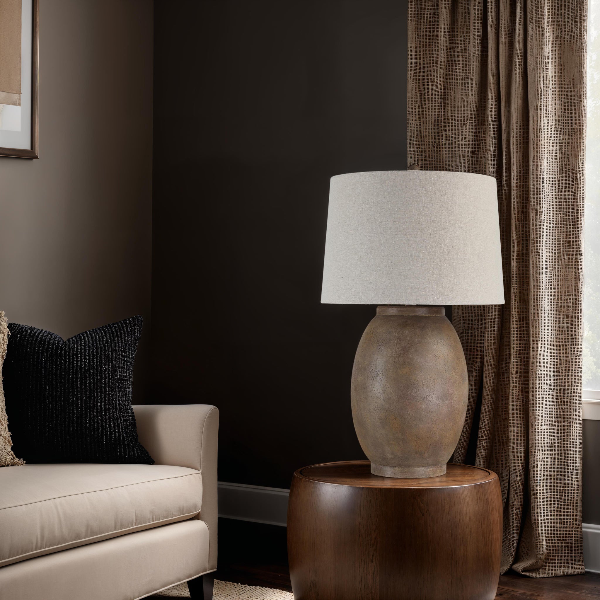 Naima Table Lamp placed beside a beige sofa in a cozy living room setting