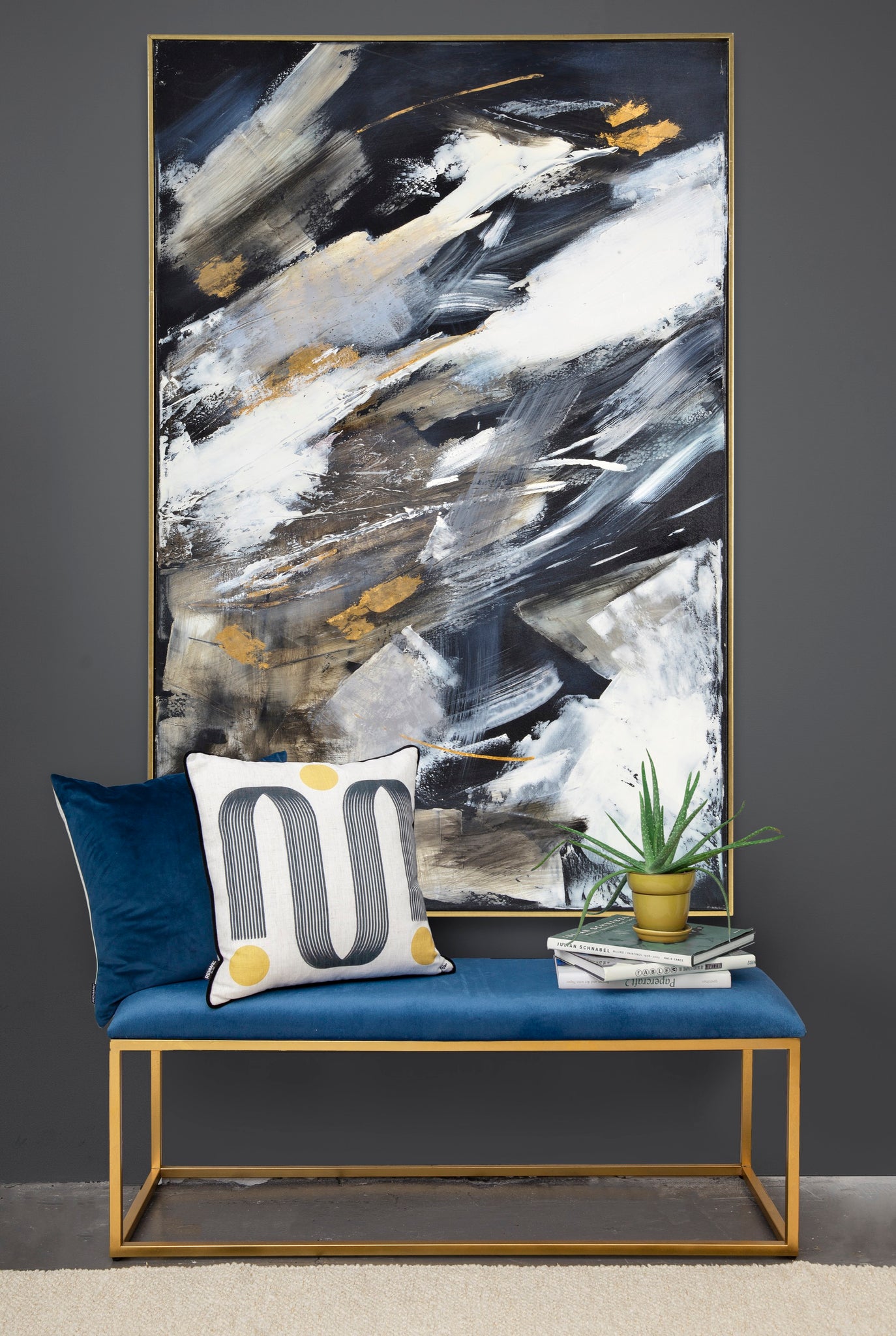 Westmount canvas art displayed above a blue bench with decorative pillows and a plant.