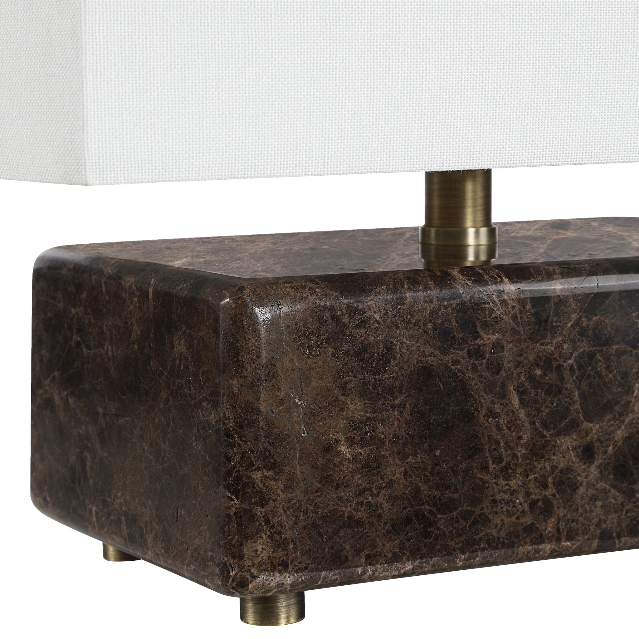 Close-up of Cabo table lamp showing dark marble base and brass details.