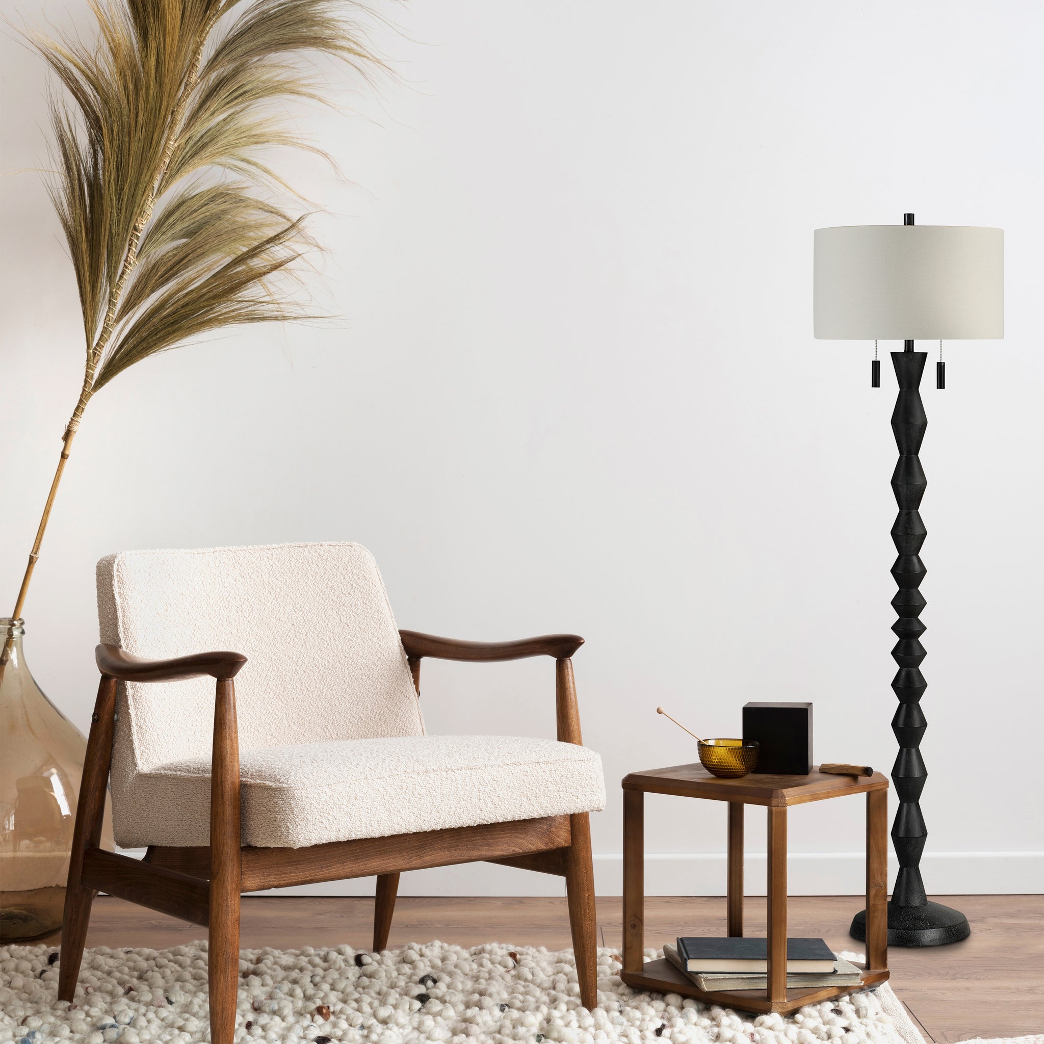Phyllis floor lamp beside a cozy chair and wooden side table in a modern living room