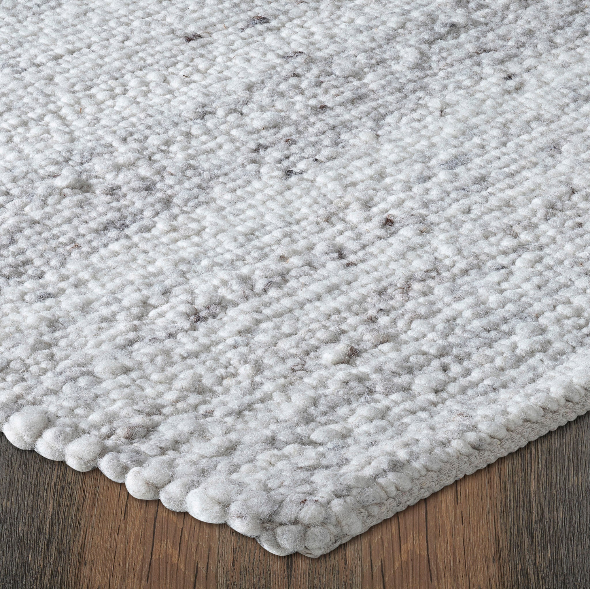 Meghan rug by Renwil, angled view highlighting the plush gray and white texture against a wooden floor.