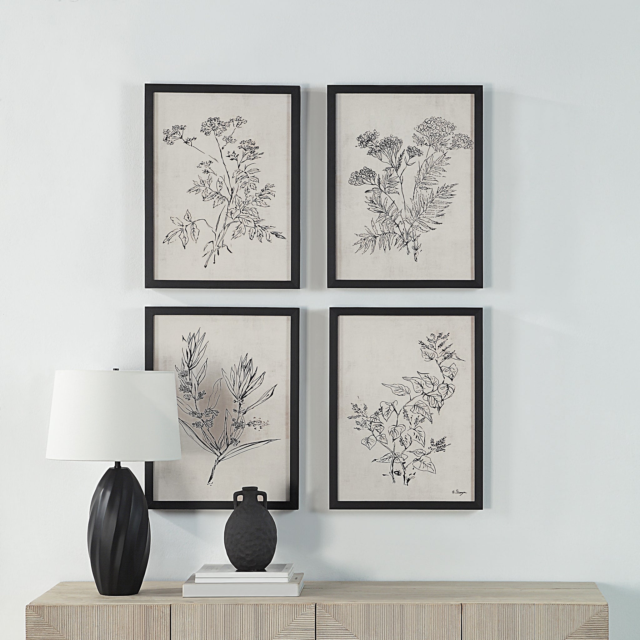 Basset Canvas Art arranged on a wall with a lamp and decorative vases on a wooden table.