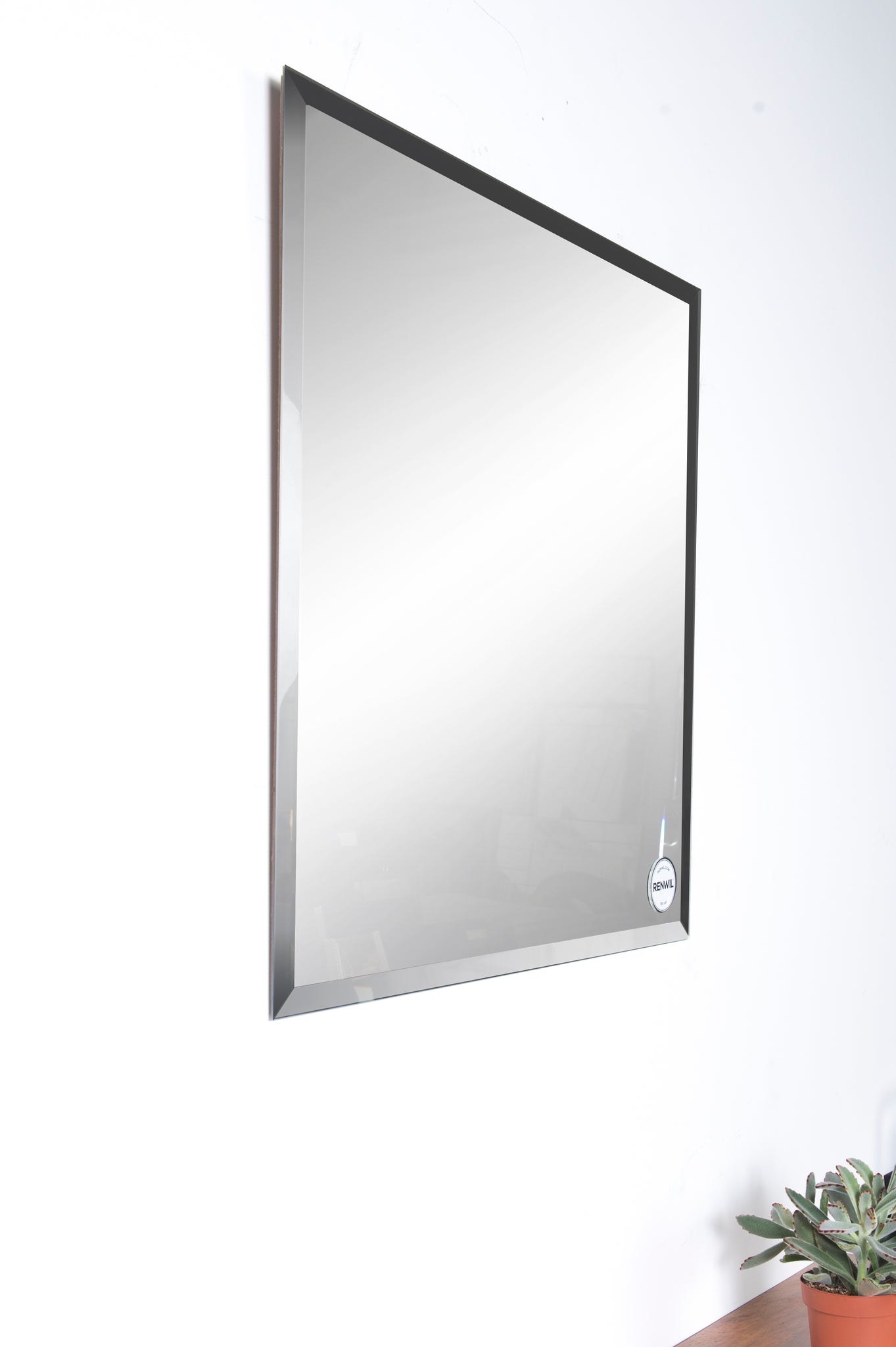 Vogue Wall Mirror featuring a rectangular shape with a black frame, angled view.