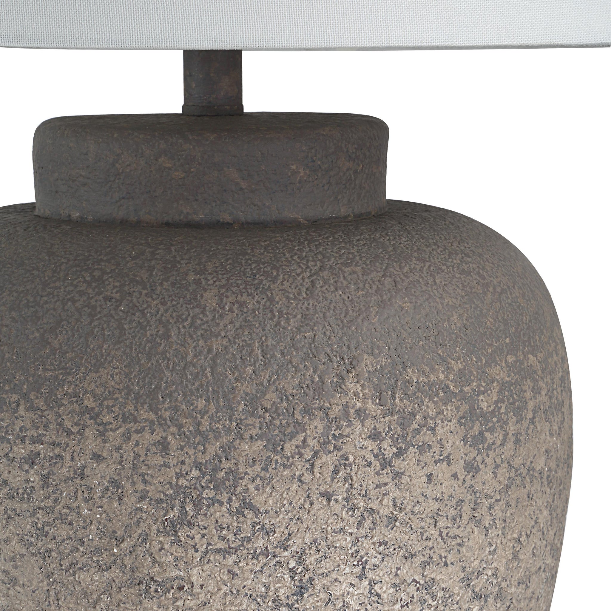 Close-up of Lattuga table lamp's textured brown ceramic base and white shade