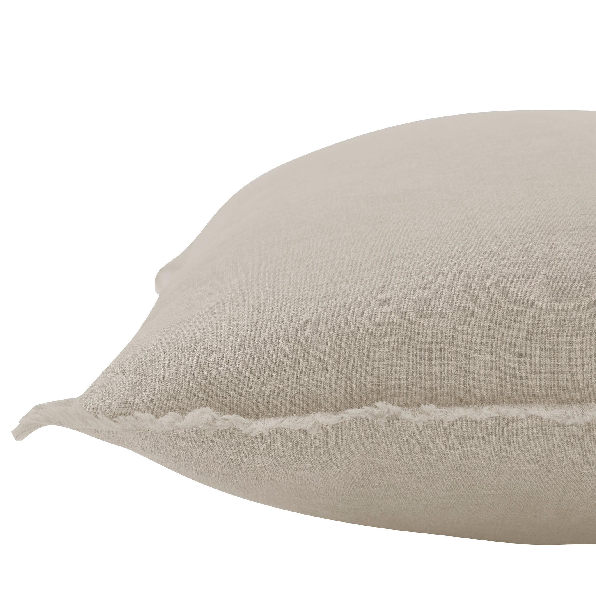 Detailed side view of Ignatia Indoor Pillow in light beige with frayed edges.