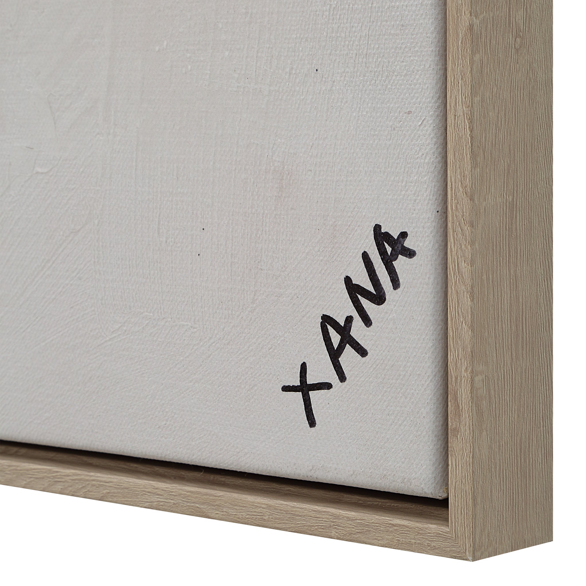 Close-up of Oriel canvas art edge showing signature 'XANA' and light wooden frame.
