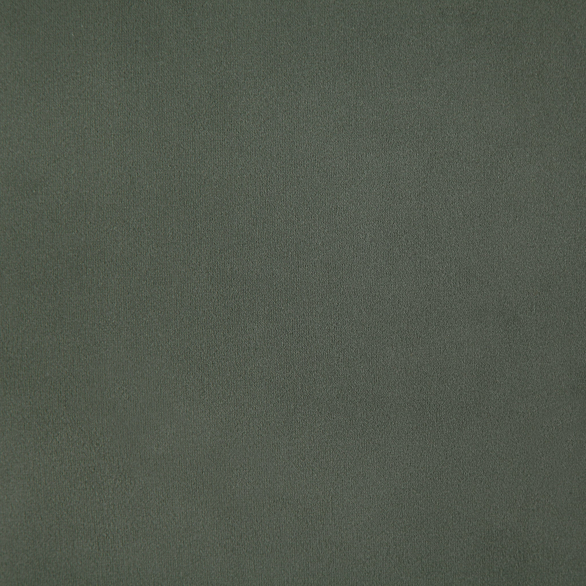 Philemon indoor pillow in dark green, close-up of soft fabric texture.