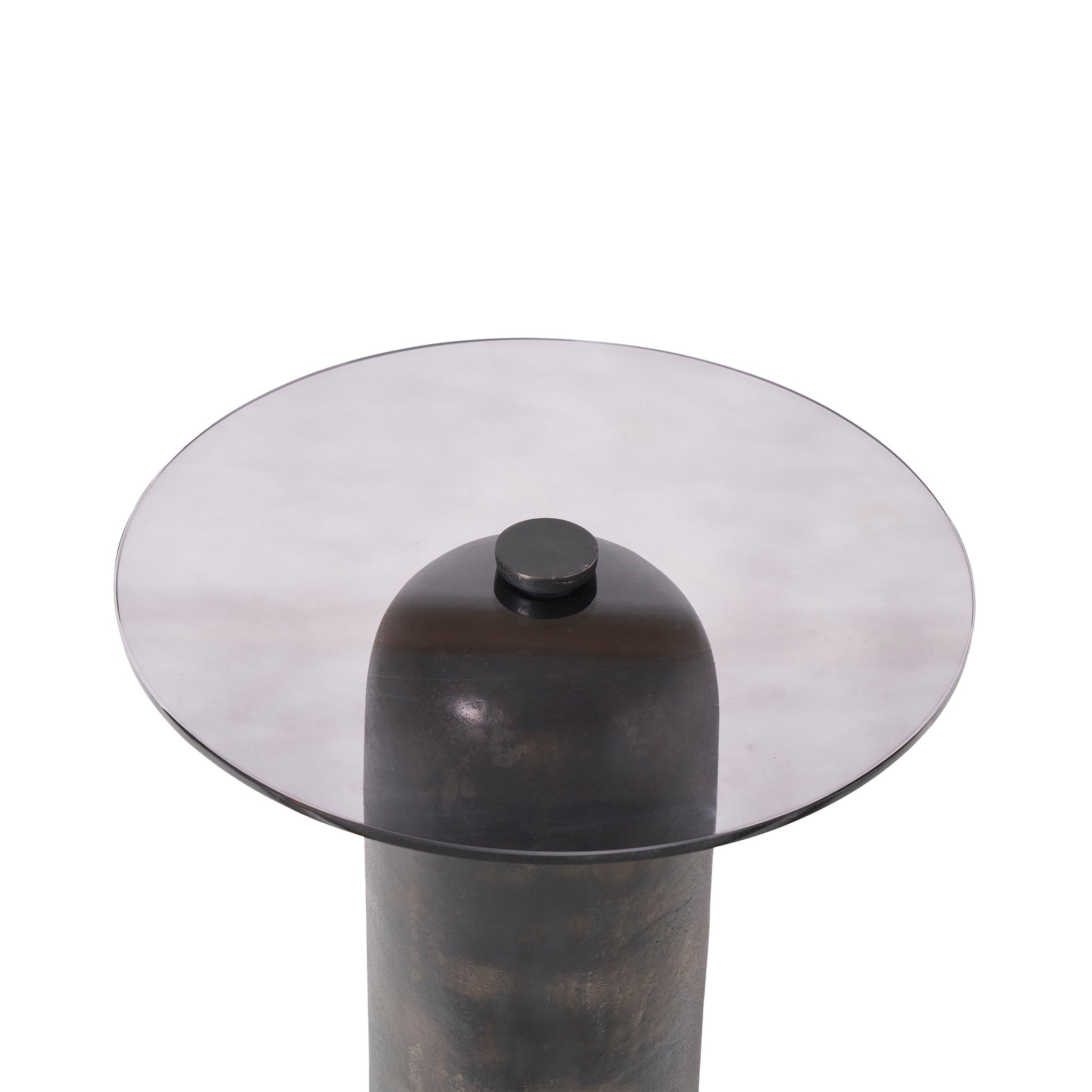 Close-up view of the Arta accent table's round smoky glass top and dark bronze base.