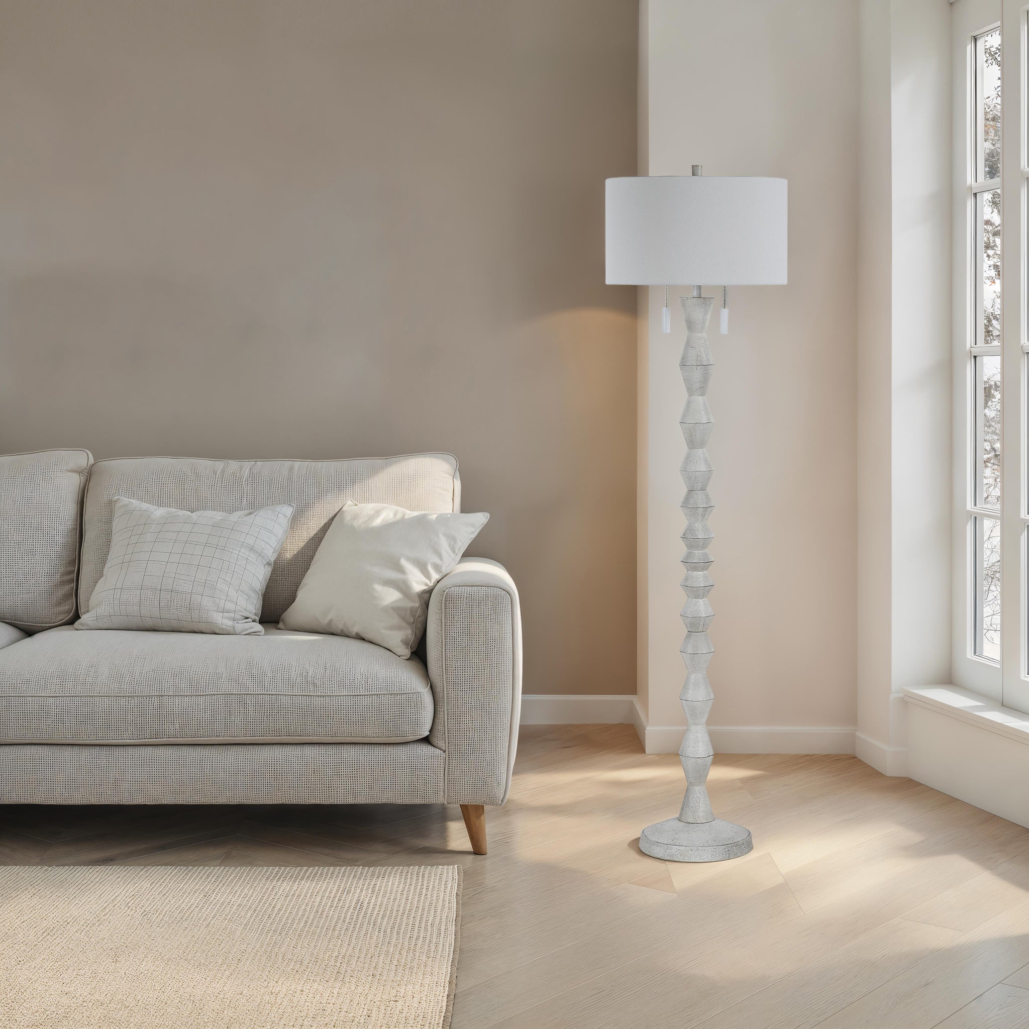 Sorriso floor lamp beside a light gray sofa in a bright room with natural light.