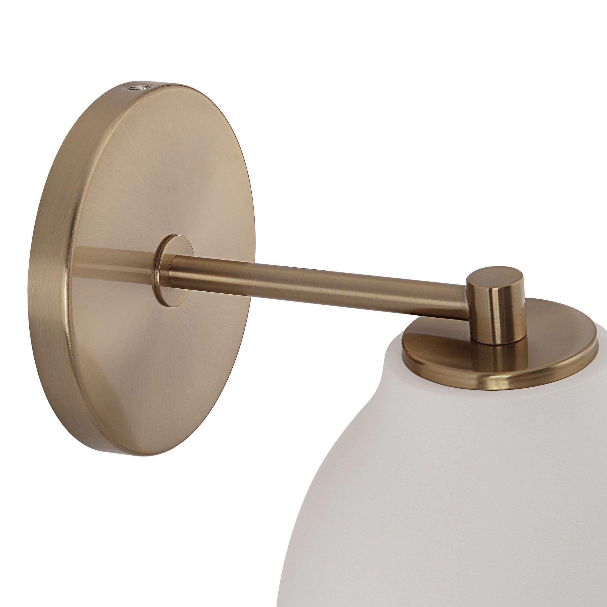 Mazia Wall Sconce featuring a brass mount and white shade, close-up view